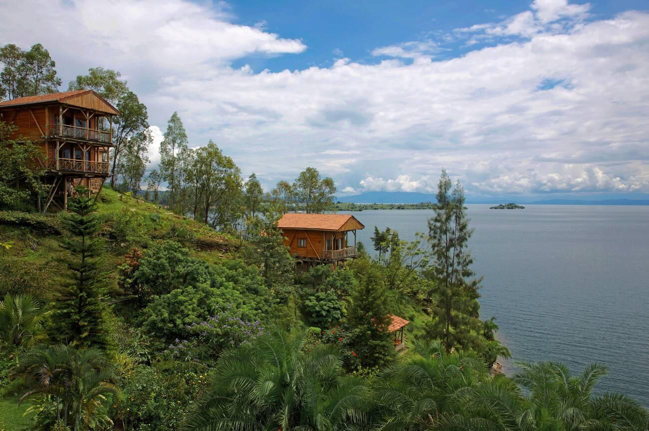 Rwanda, Lake Kivu, pavilions of Cormoran lodge posed on a green bank of Lake Kivu Rwanda, Lake Kivu, pavilions of Cormoran lodge posed on a green bank of Lake Kivu