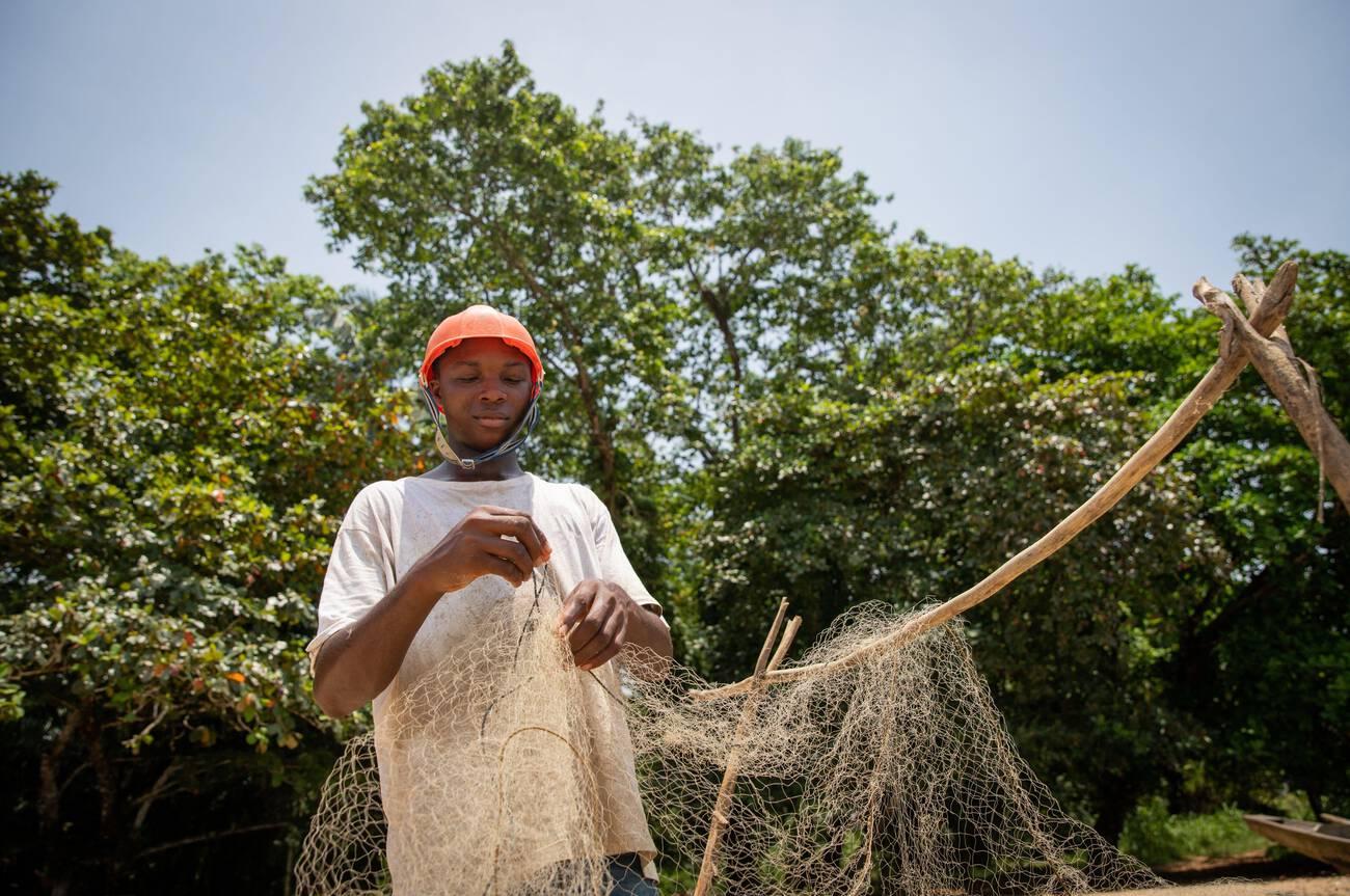 African fisherman is setting up the fishing net African fisherman is setting up the fishing net