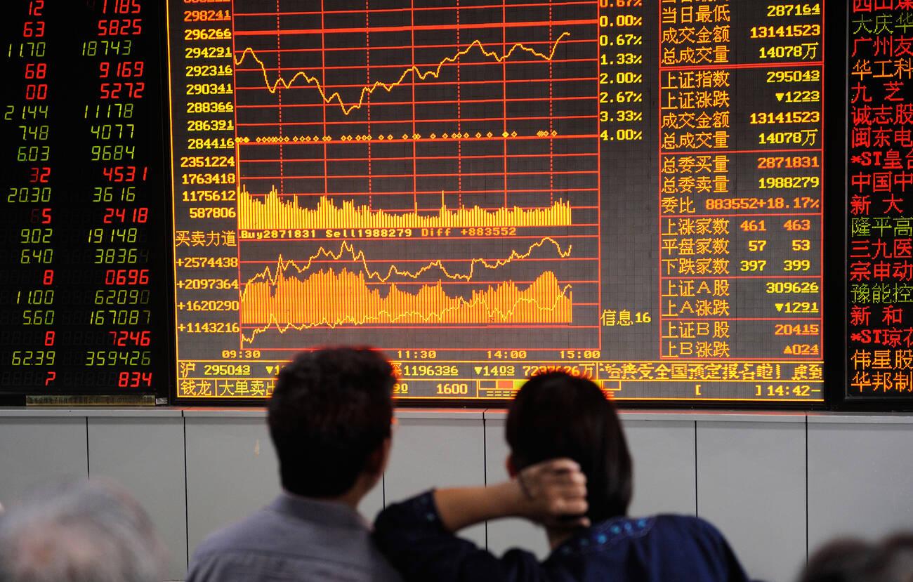 Investors look at stock index screen at a stock securities company