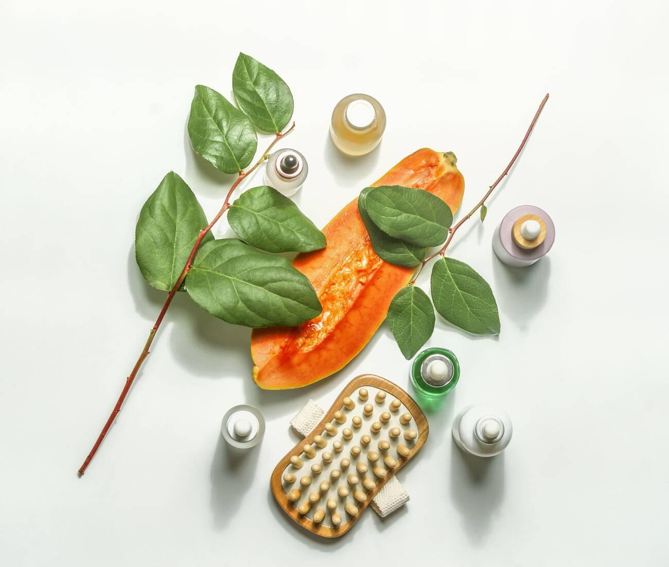 Body care cosmetic setting with halved papaya, beauty products