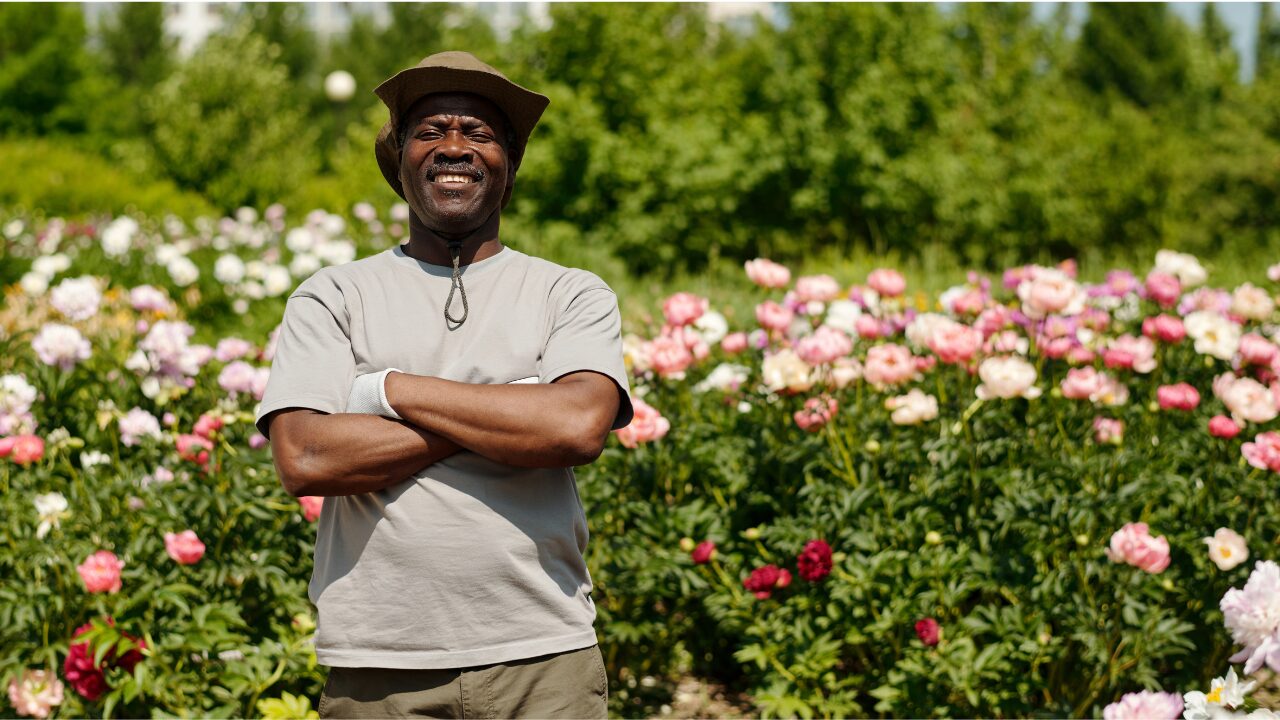 a man standing infront of a rose garden a man standing infront of a rose garden.png