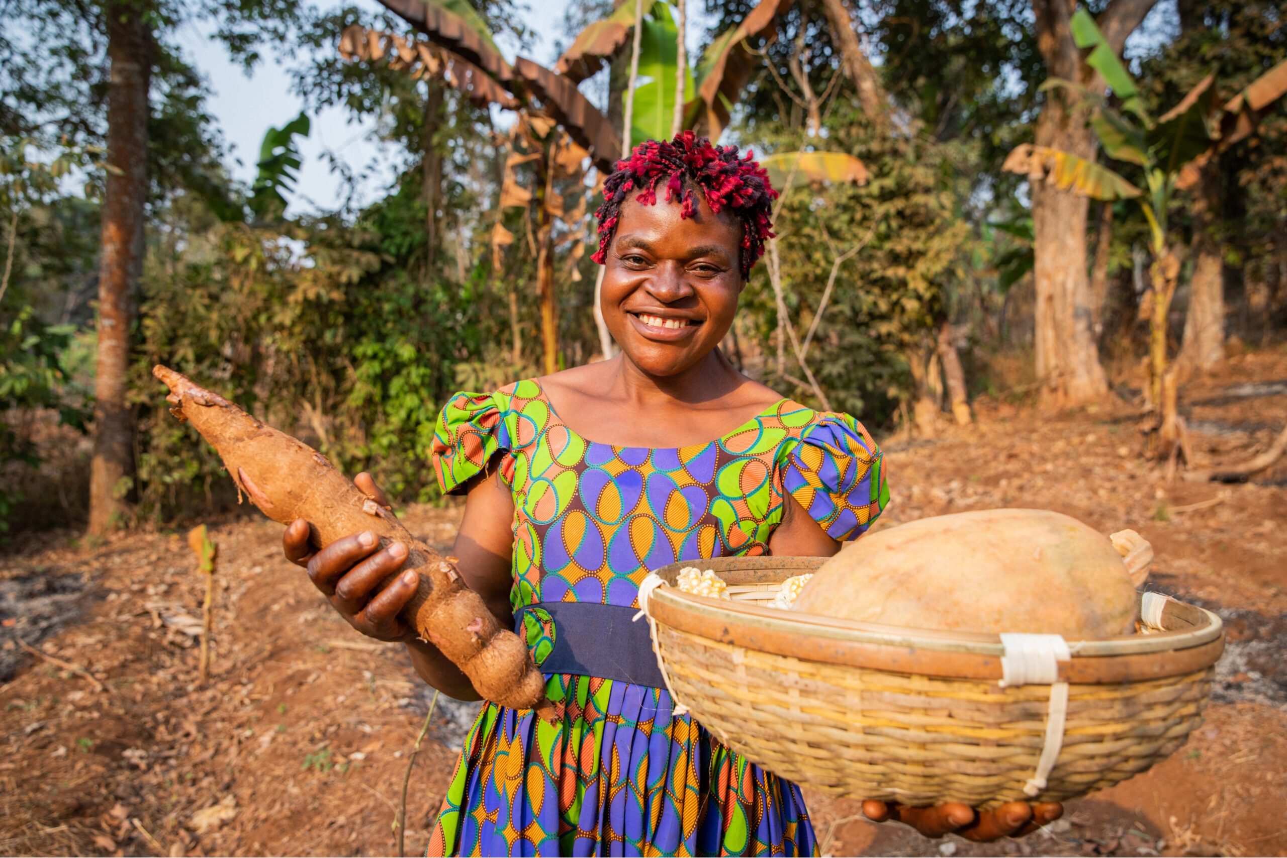 a woman holding cassava