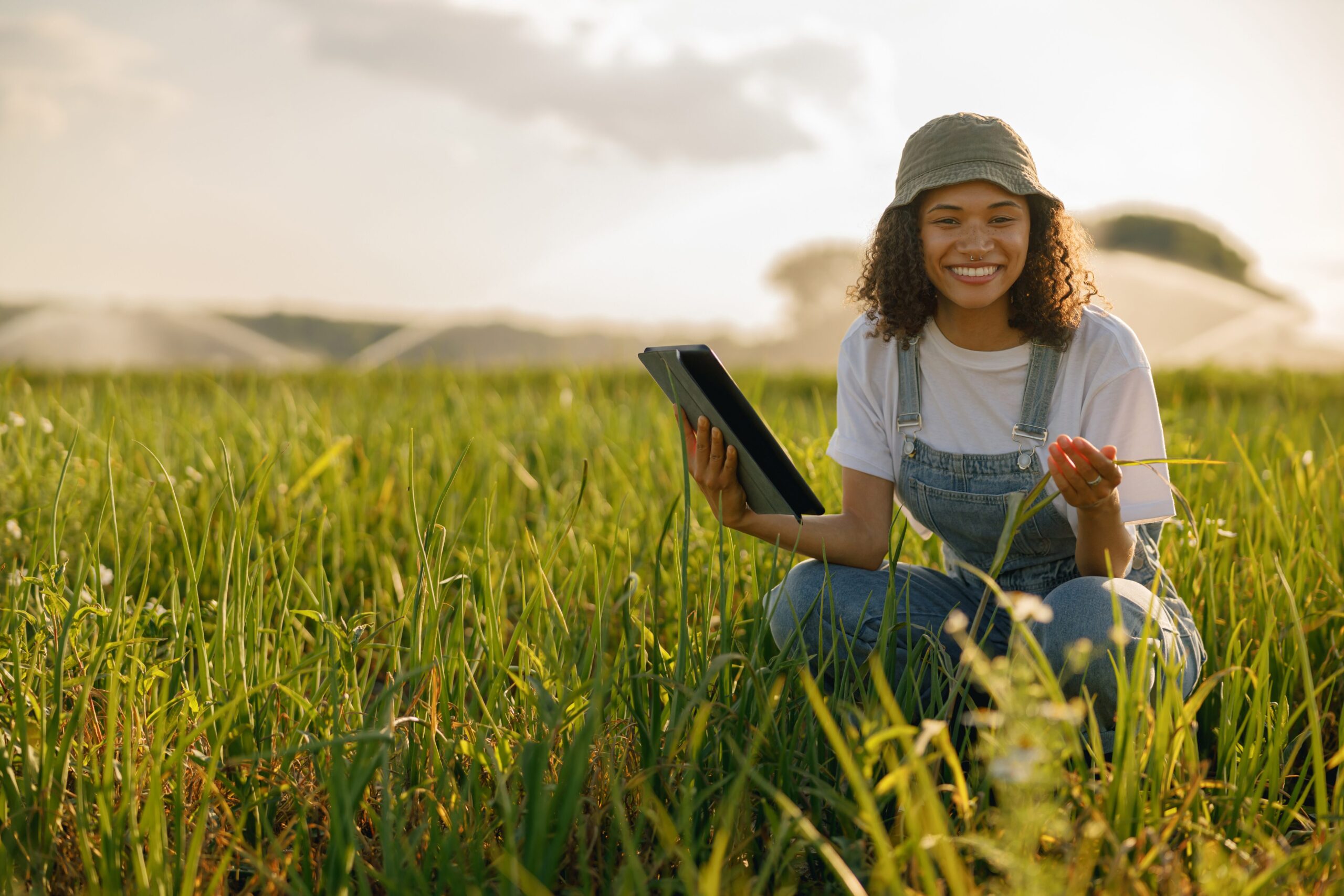 woman with tablet in crop field